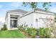 Well-manicured backyard with lush lawn, garden beds, and a charming patio, providing a private outdoor retreat at 28680 Cozy Creek Dr, Wesley Chapel, FL 33543