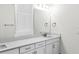 Bright bathroom featuring a double sink vanity, framed mirror, and elegant fixtures, offering a clean and modern space at 28680 Cozy Creek Dr, Wesley Chapel, FL 33543