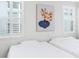 Bright bedroom with two twin beds, shuttered windows, and simple decor, offering a cozy and minimalist space at 28680 Cozy Creek Dr, Wesley Chapel, FL 33543