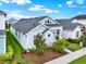 Well-maintained one-story home with a neatly landscaped yard and a clean, modern facade at 28680 Cozy Creek Dr, Wesley Chapel, FL 33543