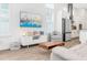 Bright living area with modern decor, hardwood floors, and stainless steel appliances in the open-concept kitchen at 28680 Cozy Creek Dr, Wesley Chapel, FL 33543