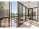 Enclosed balcony with sliding windows offering views of parking lot and landscaping at 2901 26Th W St # 317, Bradenton, FL 34205