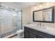 Bathroom featuring a modern vanity, framed mirror, and tiled shower with glass door at 2901 26Th W St # 317, Bradenton, FL 34205