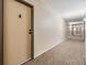 Long hallway with carpeted floors and neutral-colored walls leading to unit 317 at 2901 26Th W St # 317, Bradenton, FL 34205
