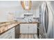Bright kitchen featuring white cabinets, wood counters, stainless steel appliances, and marble backsplash at 2901 26Th W St # 317, Bradenton, FL 34205