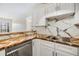 Bright kitchen featuring white cabinets, wood counters, stainless steel appliances, and marble backsplash at 2901 26Th W St # 317, Bradenton, FL 34205