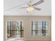 Open living room with tile flooring, a ceiling fan, large windows, and a sliding glass door to the balcony at 2901 26Th W St # 317, Bradenton, FL 34205
