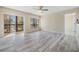 Open living room with tile flooring, a ceiling fan, large windows, and a sliding glass door to the balcony at 2901 26Th W St # 317, Bradenton, FL 34205