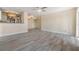 Bright open living room showcasing modern tile flooring and neutral paint scheme flowing into the adjacent kitchen area at 2901 26Th W St # 317, Bradenton, FL 34205