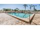 Resort-style swimming pool with clear water, palm trees, and ample lounge seating for relaxation at 2901 26Th W St # 317, Bradenton, FL 34205