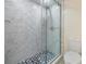 Shower with tiled walls, glass door, and tiled flooring at 2901 26Th W St # 317, Bradenton, FL 34205