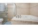 Spacious bathroom with a modern glass-enclosed shower and an elegant jacuzzi tub at 34 Hickory Ln, Safety Harbor, FL 34695