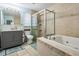 Bright bathroom featuring a jacuzzi tub and a glass-enclosed shower, and a grey vanity at 34 Hickory Ln, Safety Harbor, FL 34695