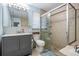 Bright bathroom featuring a glass-enclosed shower, light blue walls, and a grey vanity at 34 Hickory Ln, Safety Harbor, FL 34695