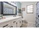 Modern bathroom featuring a large mirror, marble floors, and stylish fixtures at 34 Hickory Ln, Safety Harbor, FL 34695