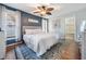 Serene bedroom with wood accent wall, ceiling fan, and adjacent bathroom, creating a relaxing retreat at 34 Hickory Ln, Safety Harbor, FL 34695