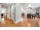Inviting dining room showcasing wood floors, a modern ceiling fan, and an open layout with views of the living area at 34 Hickory Ln, Safety Harbor, FL 34695