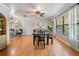 Bright dining area featuring wood flooring, large windows, and a cozy ambiance perfect for Gathering meals at 34 Hickory Ln, Safety Harbor, FL 34695