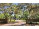 Scenic road leading into park with historic stone entrance and views of lush trees at 34 Hickory Ln, Safety Harbor, FL 34695