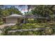 Charming single-story home with a stone accent, well-manicured lawn, and an attached two-car garage at 34 Hickory Ln, Safety Harbor, FL 34695