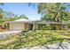 Charming single-story home with a stone accent, well-manicured lawn, and an attached two-car garage at 34 Hickory Ln, Safety Harbor, FL 34695