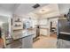 Well-lit kitchen featuring granite countertops, ample counter space, and seamless transition to dining area at 34 Hickory Ln, Safety Harbor, FL 34695