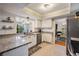 Modern kitchen features granite countertops, stainless steel appliances, and a convenient pass-through to the patio at 34 Hickory Ln, Safety Harbor, FL 34695