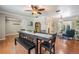 Spacious living area with a dining table and chairs, complemented by an open layout and modern lighting fixtures at 34 Hickory Ln, Safety Harbor, FL 34695