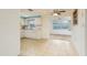 A charming kitchen with white cabinets, bright lighting, and tiled flooring, ready for culinary adventures at 3706 Cambridge St, New Port Richey, FL 34652