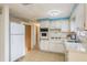 Functional kitchen featuring white appliances, ample counter space, and a layout designed for ease of use at 3706 Cambridge St, New Port Richey, FL 34652