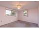 Bright bedroom with two large windows providing natural light, carpet flooring, and a cozy atmosphere at 3706 Cambridge St, New Port Richey, FL 34652