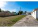 Expansive backyard features a concrete patio, green lawn, and a privacy fence for outdoor enjoyment at 3706 Cambridge St, New Port Richey, FL 34652