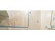Tight bathroom view features dated seashell wallpaper, tiled walls, and a shower with basic fixtures and finishes at 3706 Cambridge St, New Port Richey, FL 34652