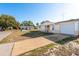 A well-maintained one-story home with a driveway, attached garage, and green front yard on a sunny day at 3706 Cambridge St, New Port Richey, FL 34652