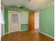 The vibrant bedroom offers patterned flooring, bold green walls, and natural lighting at 3706 Cambridge St, New Port Richey, FL 34652