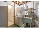 A functional laundry area features a stackable washer-dryer, sink, and walk-in shower at 3706 Cambridge St, New Port Richey, FL 34652