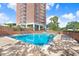 Outdoor swimming pool with lounge chairs and a view of the condo building at 4015 Bayshore Blvd # 8E, Tampa, FL 33611