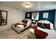 Comfortable bedroom featuring two cozy beds with white headboards, rust-colored throws, and teal accent pillows at 4644 Bay Crest Dr, Tampa, FL 33615