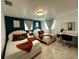 Inviting bedroom featuring two cozy beds with white headboards, rust-colored throws, teal accent pillows, and a desk at 4644 Bay Crest Dr, Tampa, FL 33615