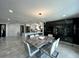 Bright dining area with a granite table, modern lighting, and open layout connected to the kitchen at 4644 Bay Crest Dr, Tampa, FL 33615