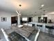 Open dining area with a modern chandelier, granite table, and seamless view into the kitchen at 4644 Bay Crest Dr, Tampa, FL 33615