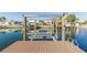Well-maintained private dock featuring a boat lift and serene canal views at 4644 Bay Crest Dr, Tampa, FL 33615