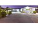 Contemporary one-story home with a spacious driveway, modern garage door, manicured shrubs, and inviting blue front door at 4644 Bay Crest Dr, Tampa, FL 33615
