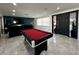 Bright game room featuring a red felt pool table, large TV, and modern decor at 4644 Bay Crest Dr, Tampa, FL 33615