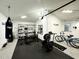 Garage gym with weights, punching bag, squat rack, and exercise equipment. 'Be Savage' wall art at 4644 Bay Crest Dr, Tampa, FL 33615