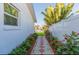 Charming walkway with lush garden and colorful flowers, leading to a well-manicured yard at 4644 Bay Crest Dr, Tampa, FL 33615