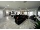 Open-concept living space featuring sleek floors, ample seating, integrated lighting, and a modern design at 4644 Bay Crest Dr, Tampa, FL 33615