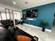 Comfortable living room with a plush sectional sofa, large television, and modern accents at 4644 Bay Crest Dr, Tampa, FL 33615