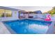 Beautiful pool area with gazebo, lounge chairs, flamingo float and well-maintained patio, perfect for outdoor entertaining at 4644 Bay Crest Dr, Tampa, FL 33615