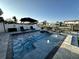 Beautiful pool with seating and lounge chairs, surrounded by a privacy fence and landscaping at 4644 Bay Crest Dr, Tampa, FL 33615